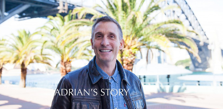 man smiling in front of the harbour bridge