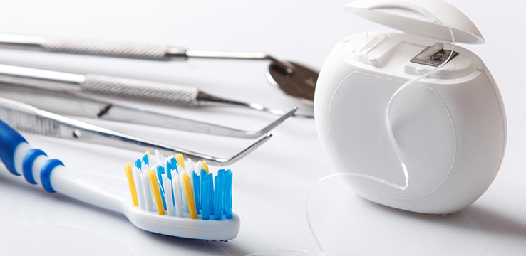 dental tools on white background toothbrush, floss, picks and mirror